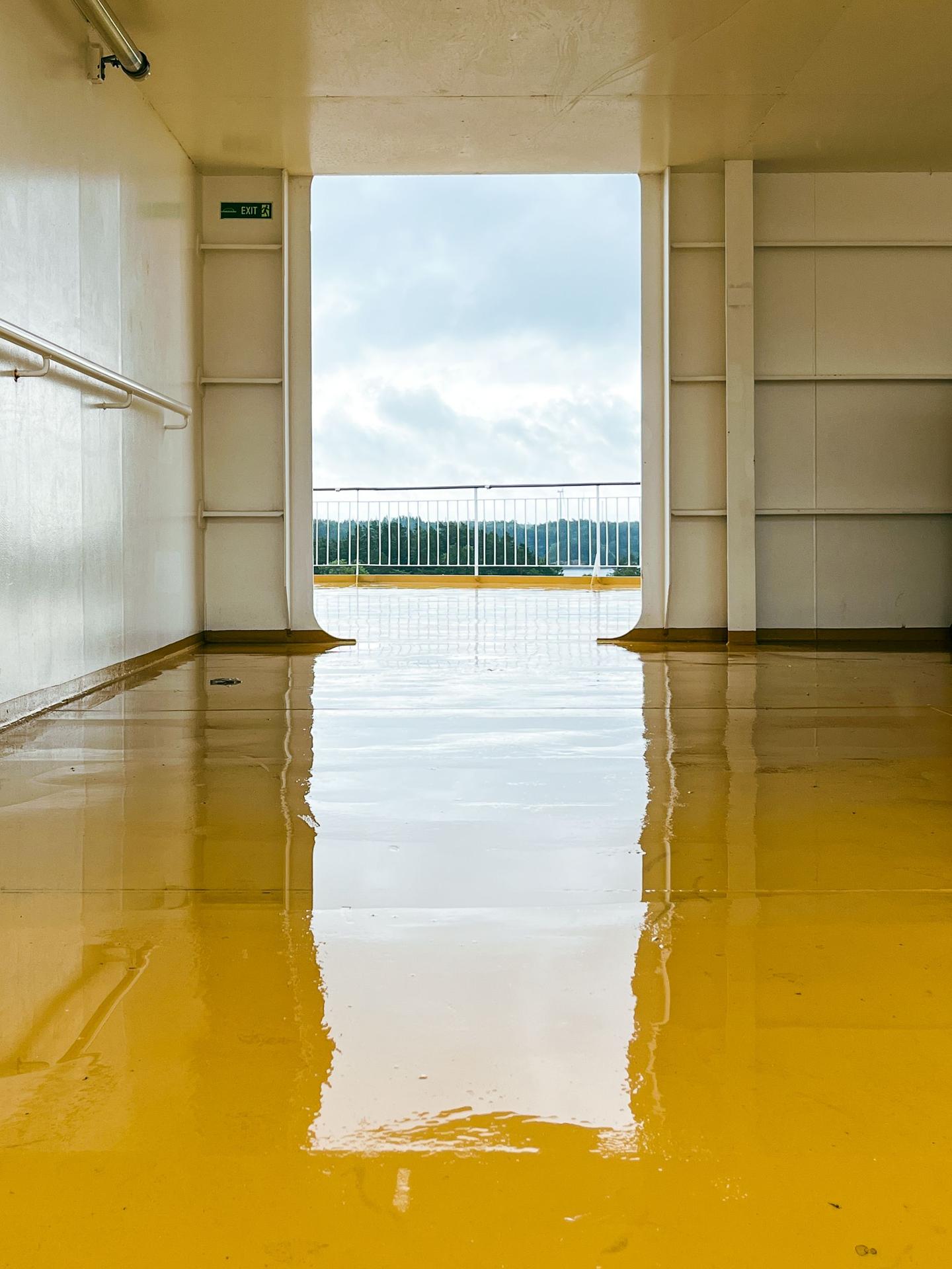 Glossy yellow epoxy flooring in a commercial hallway